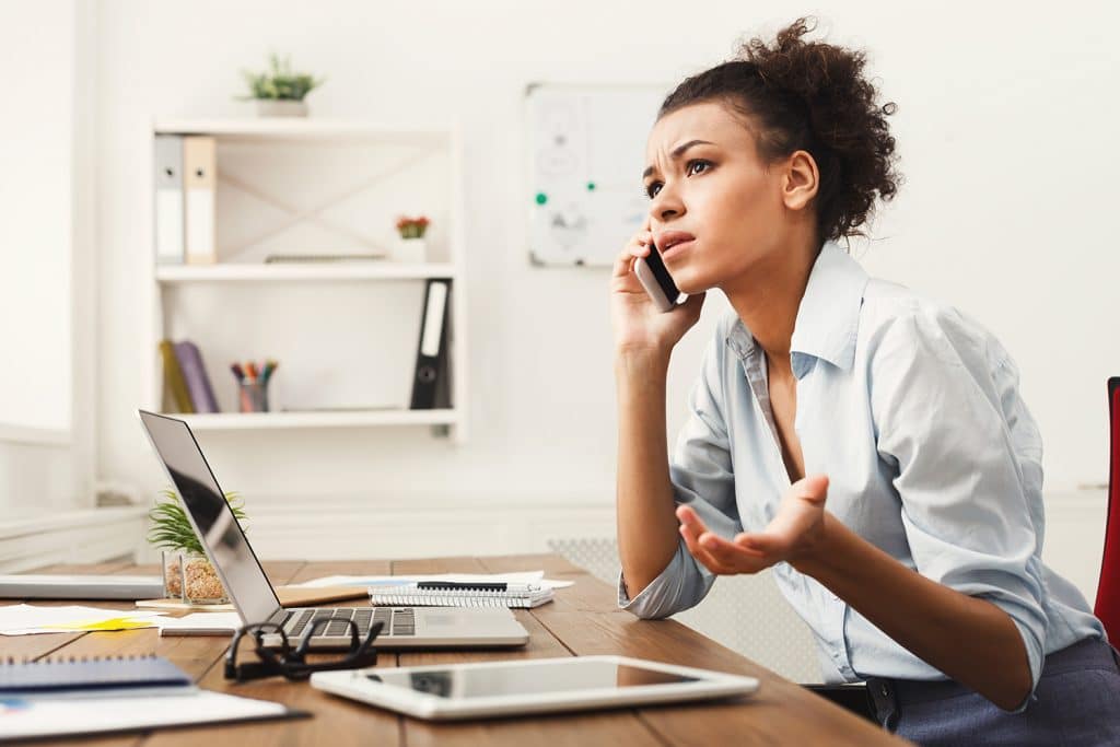 working woman on phone looking concerned