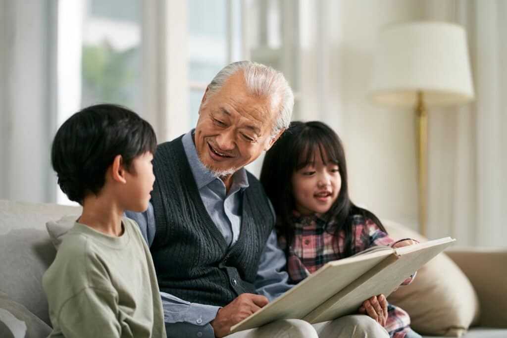 grandfather reading to his grandkids