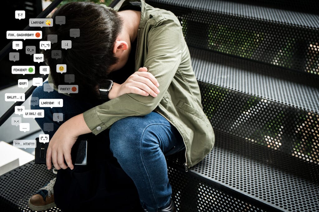 sad child sitting on stairs with head down and lots of negative messages