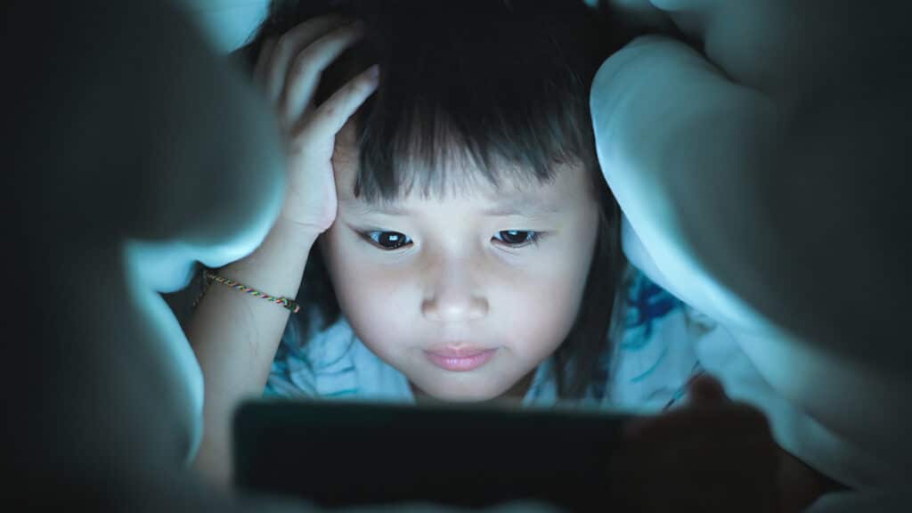 little girl looking at laptop