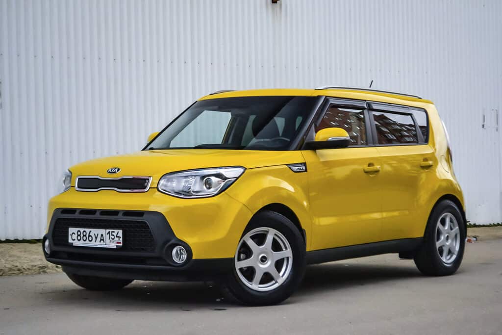 yellow kia vehicle with european license plate